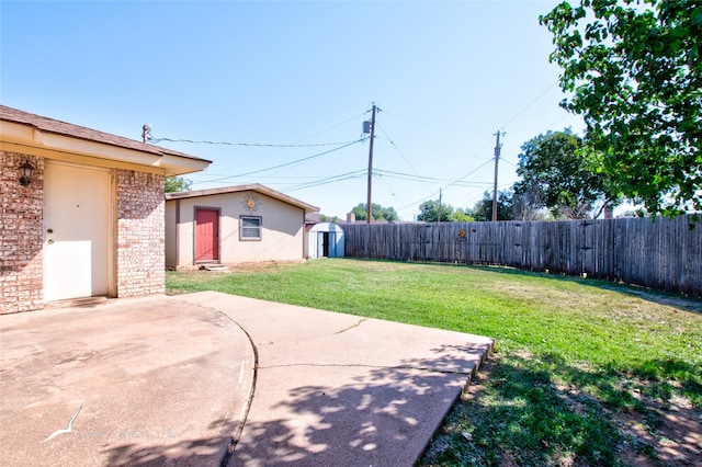 view of yard featuring a patio area and a storage shed