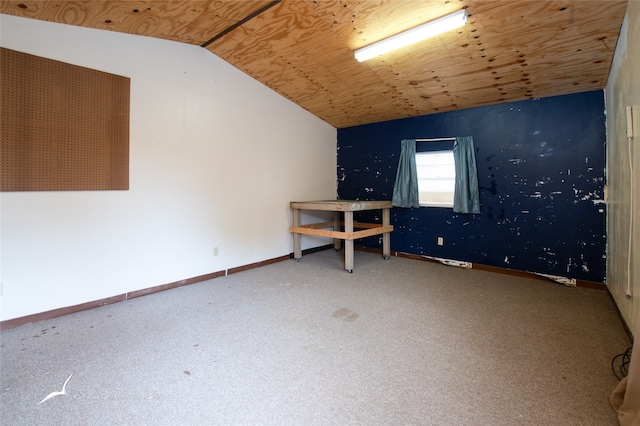 carpeted empty room featuring lofted ceiling and wood ceiling