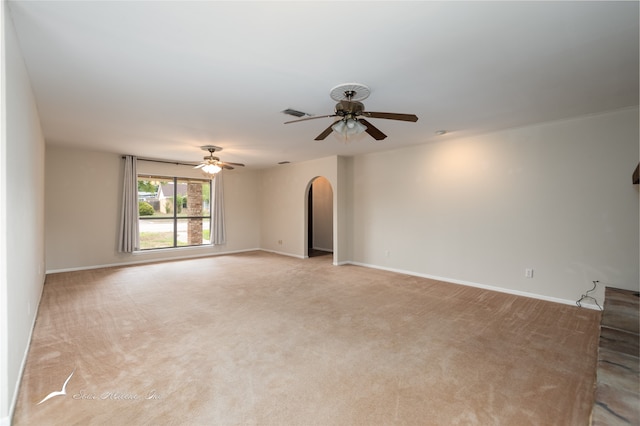 spare room with light colored carpet and ceiling fan