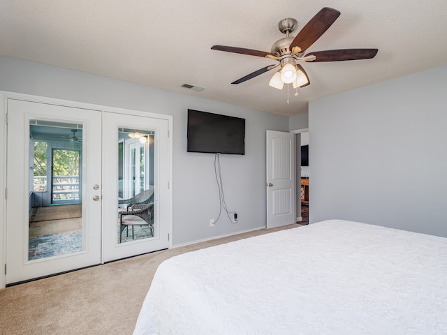 carpeted bedroom featuring ceiling fan, a textured ceiling, access to outside, and french doors