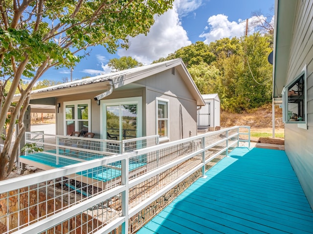 view of pool with a wooden deck