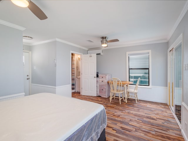 bedroom with ceiling fan, crown molding, wood-type flooring, and ensuite bathroom