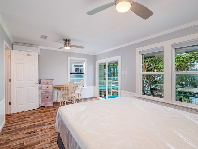 bedroom featuring ceiling fan, hardwood / wood-style floors, multiple windows, and access to outside