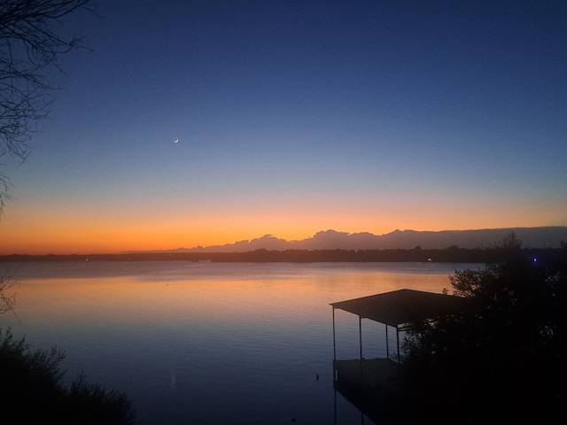 view of water feature with a boat dock and a mountain view