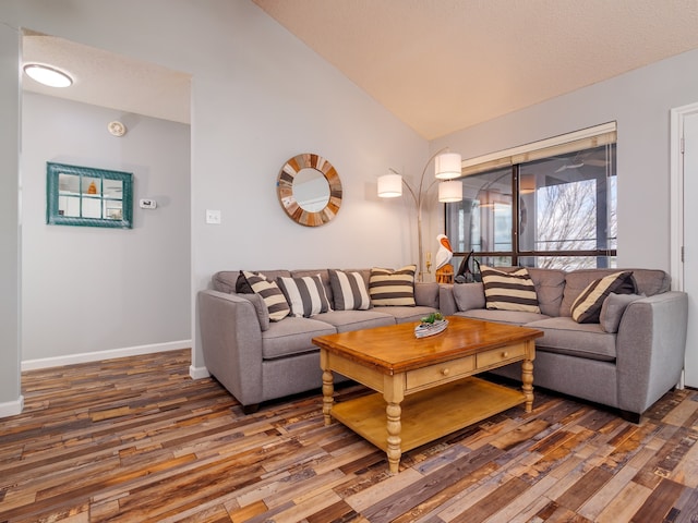 living room featuring dark hardwood / wood-style flooring, a textured ceiling, and vaulted ceiling