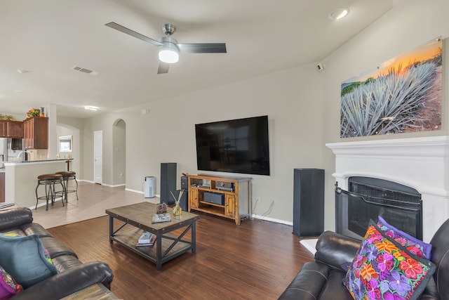 living room with ceiling fan and hardwood / wood-style flooring