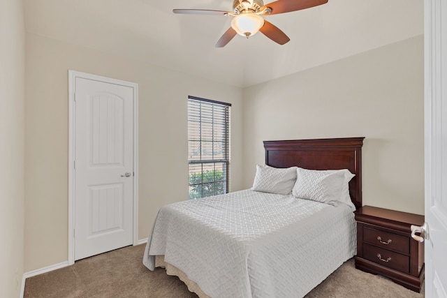 bedroom featuring light carpet and ceiling fan