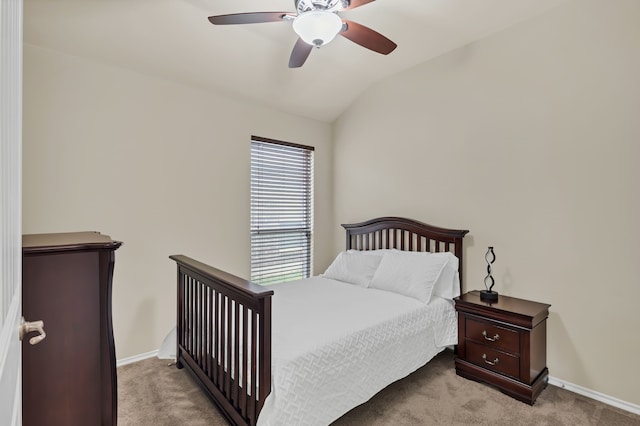 carpeted bedroom with vaulted ceiling and ceiling fan