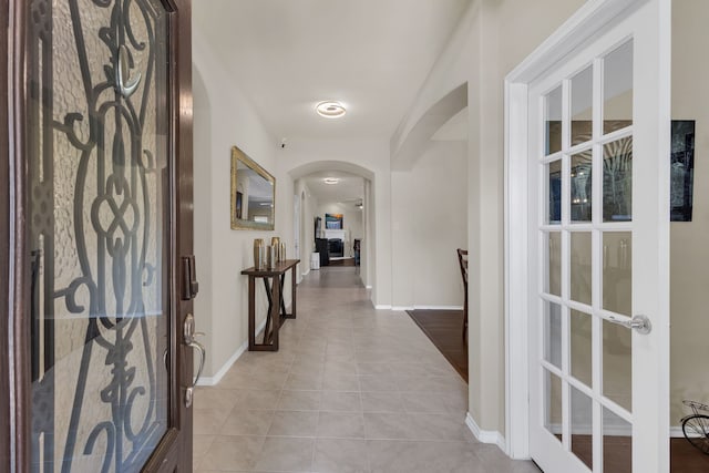 corridor featuring light tile patterned floors