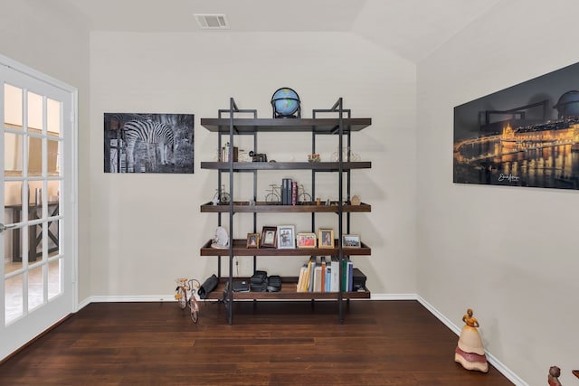 interior space featuring dark hardwood / wood-style flooring and vaulted ceiling