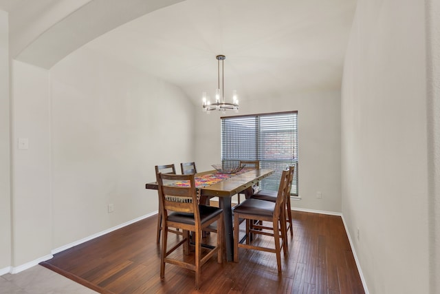 dining area featuring wood-type flooring and a chandelier