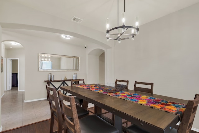 dining area featuring light hardwood / wood-style flooring and a chandelier