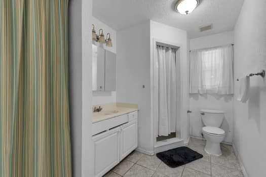 bathroom with tile patterned floors, toilet, and vanity