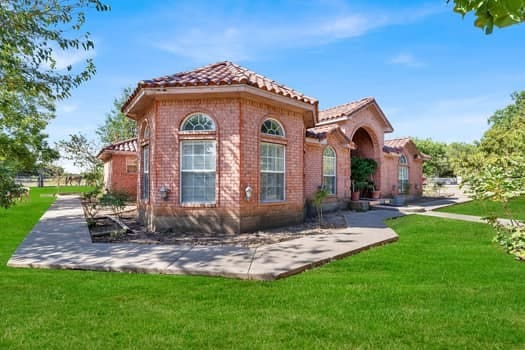 rear view of property with a yard