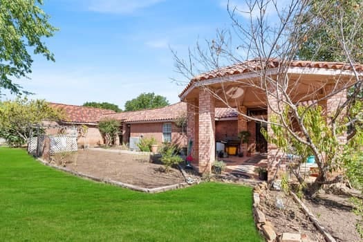 rear view of property with a lawn