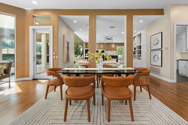 dining space featuring a healthy amount of sunlight, ceiling fan, and light hardwood / wood-style flooring