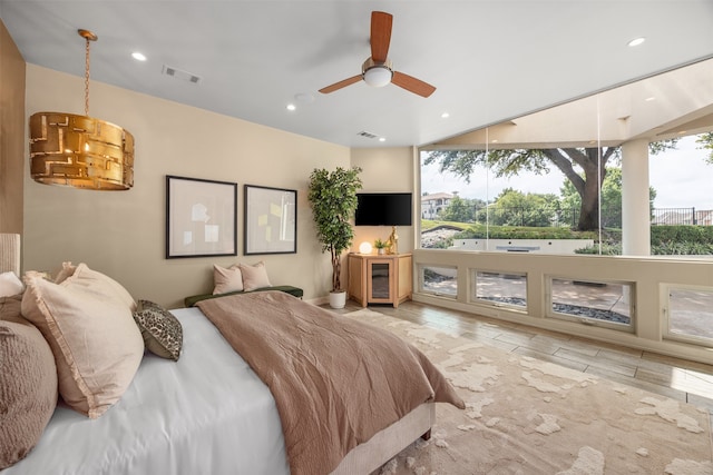 bedroom with light hardwood / wood-style flooring and ceiling fan