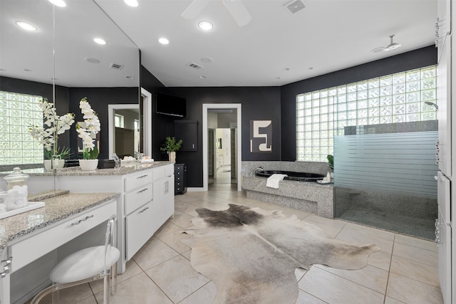 bathroom with vanity, a bathing tub, ceiling fan, and tile patterned flooring