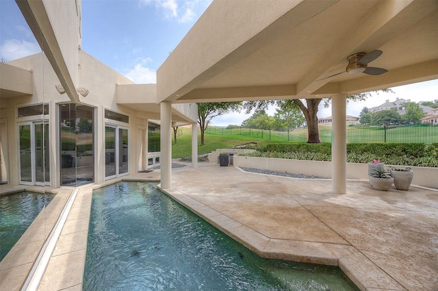 view of pool featuring ceiling fan and a patio area