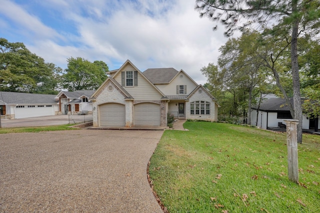 view of front of home with a front yard and a garage