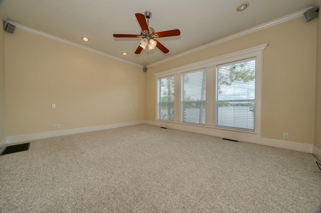 carpeted spare room featuring ceiling fan and ornamental molding