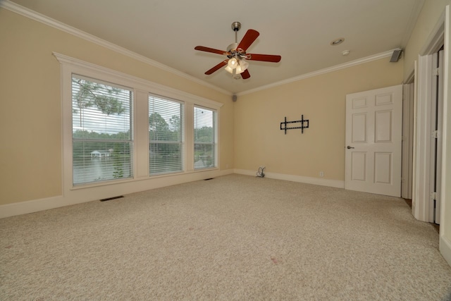 spare room with carpet flooring, ceiling fan, and ornamental molding