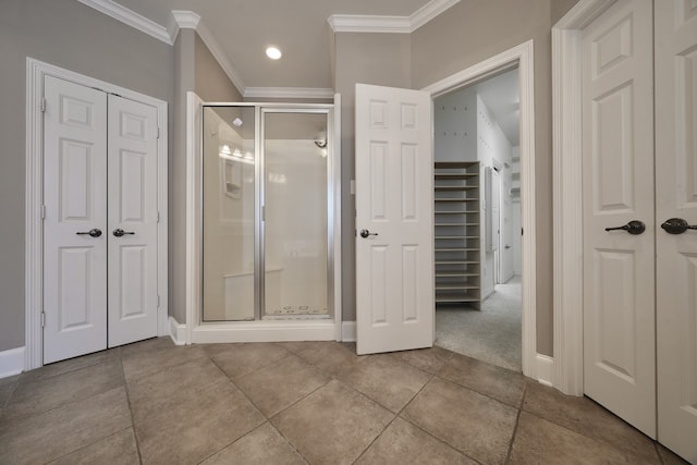 bathroom with crown molding, walk in shower, and tile patterned floors