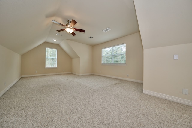 bonus room featuring light colored carpet, lofted ceiling, and ceiling fan