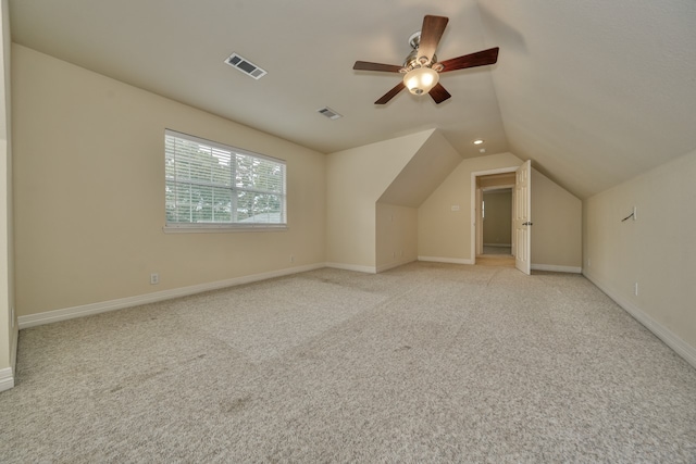 additional living space with lofted ceiling, ceiling fan, and light carpet