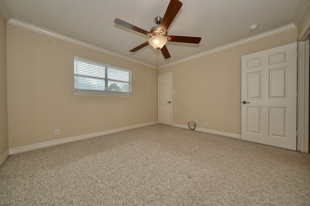 carpeted empty room with ceiling fan and crown molding