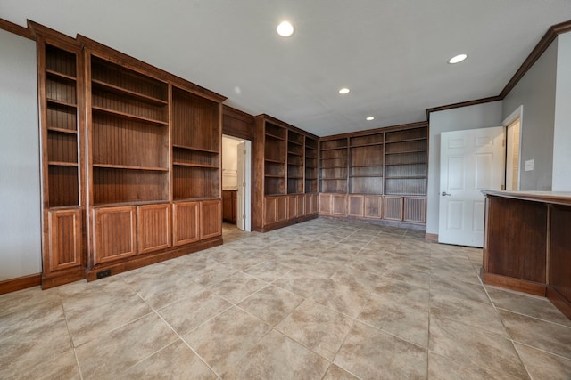 spare room featuring built in features, light tile patterned floors, and ornamental molding