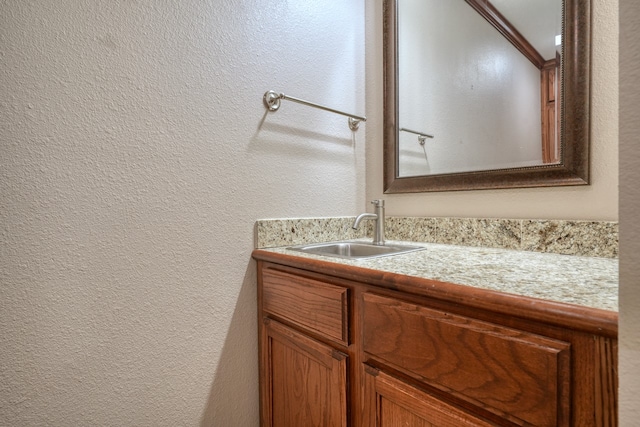 bathroom with ornamental molding and vanity