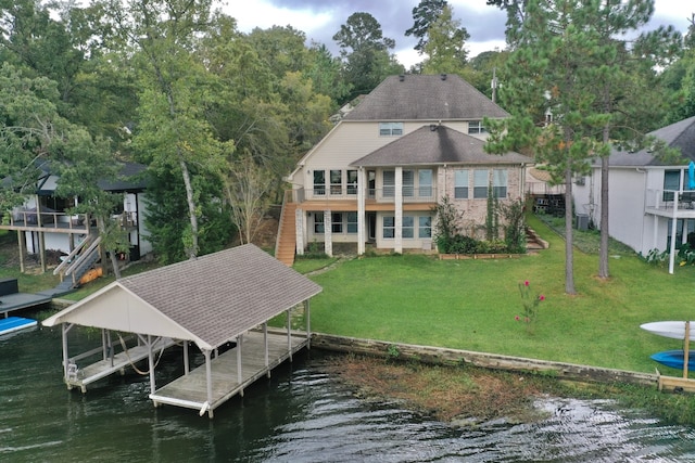 view of dock with a water view and a yard