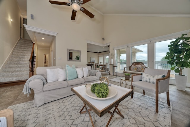 living room with ornamental molding, high vaulted ceiling, and ceiling fan