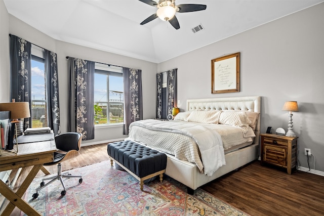 bedroom with ceiling fan, dark hardwood / wood-style flooring, and vaulted ceiling