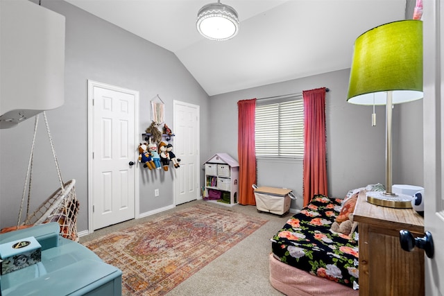 carpeted bedroom featuring lofted ceiling