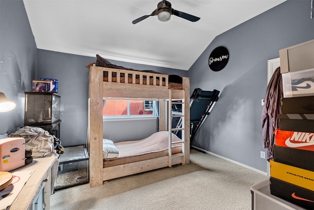 carpeted bedroom featuring ceiling fan and vaulted ceiling