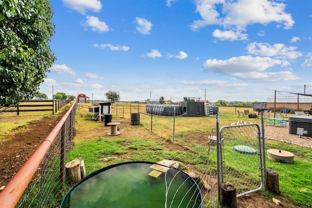 view of home's community featuring a rural view and a yard