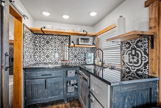 kitchen with backsplash, extractor fan, stainless steel gas cooktop, sink, and dark hardwood / wood-style floors