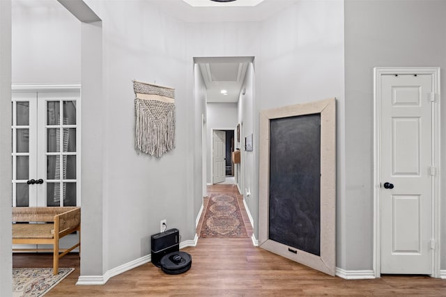 hallway with hardwood / wood-style flooring