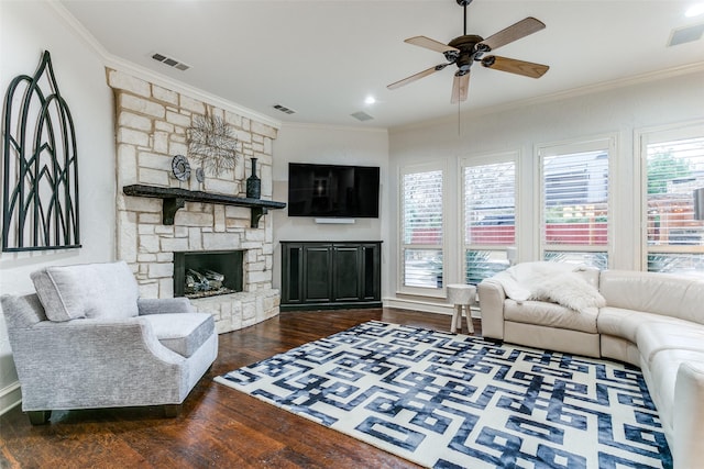 living room featuring crown molding, dark hardwood / wood-style floors, and a stone fireplace