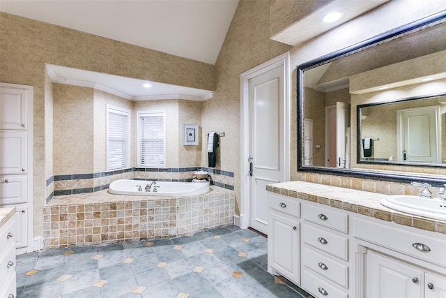 bathroom with a relaxing tiled tub, ornamental molding, vanity, and vaulted ceiling