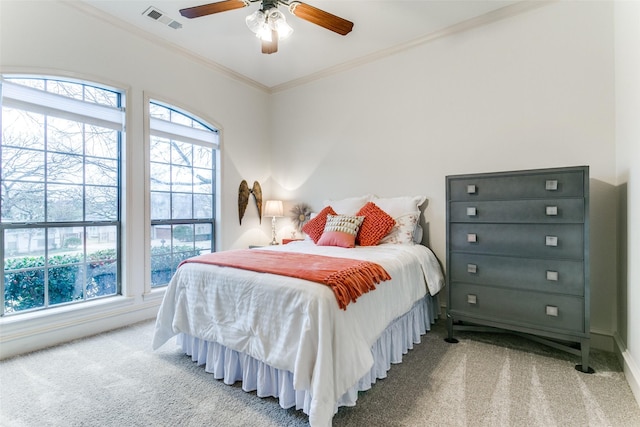 bedroom featuring ceiling fan, ornamental molding, and carpet floors