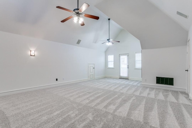 unfurnished living room featuring high vaulted ceiling and light carpet