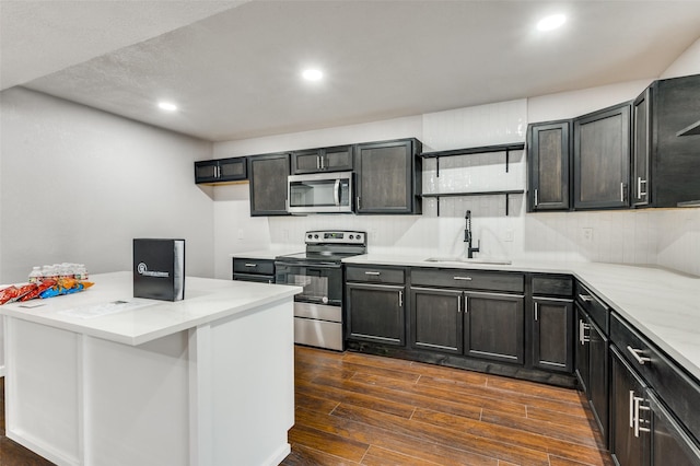 kitchen with tasteful backsplash, sink, and appliances with stainless steel finishes