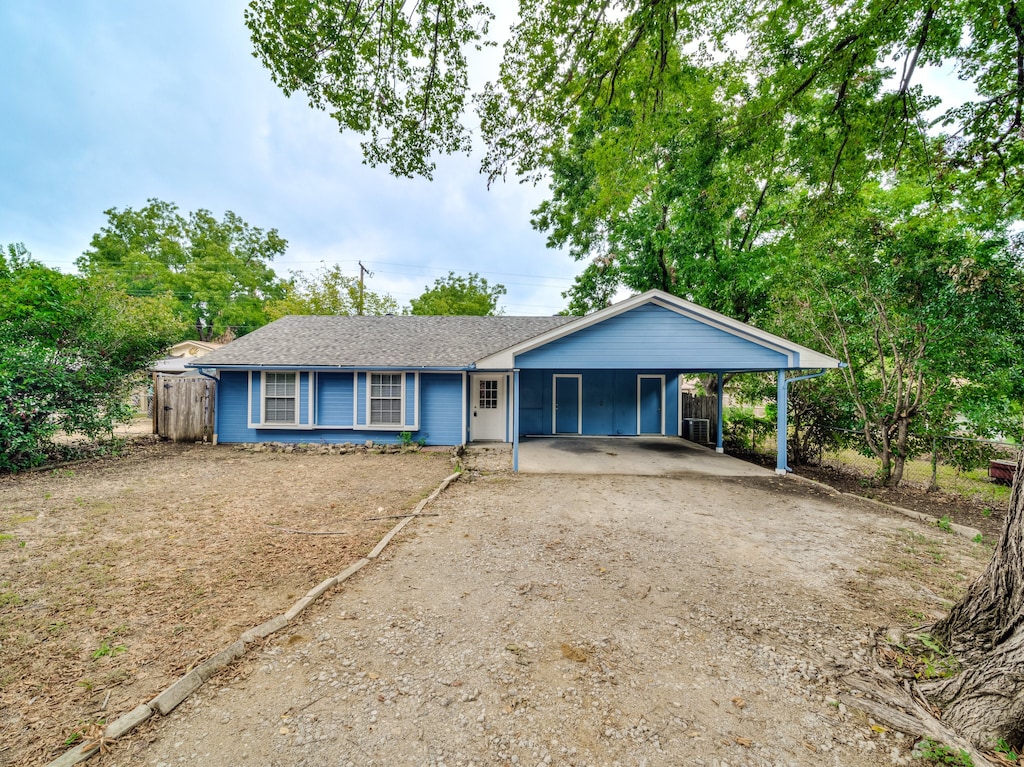 ranch-style home featuring a carport