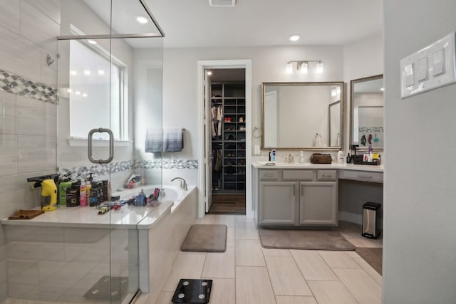 bathroom with tile patterned flooring, vanity, and independent shower and bath