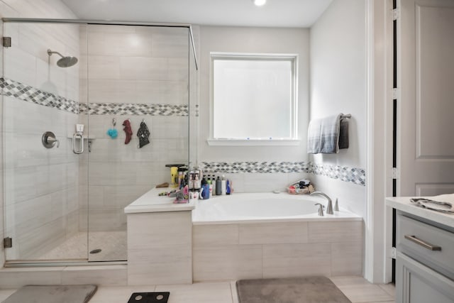 bathroom featuring tile patterned floors, independent shower and bath, and vanity