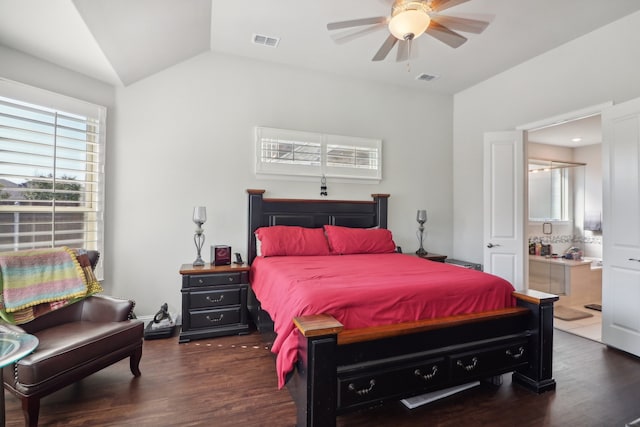 bedroom featuring dark wood-type flooring, lofted ceiling, ensuite bathroom, and ceiling fan