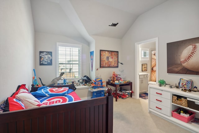 bedroom featuring ensuite bath, lofted ceiling, and light colored carpet